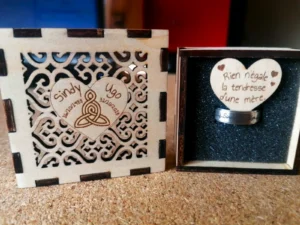 Intérieur de boîte à bijoux en bois gravé avec le message "Rien n'égale l'amour d'une mère" dans un cœur.